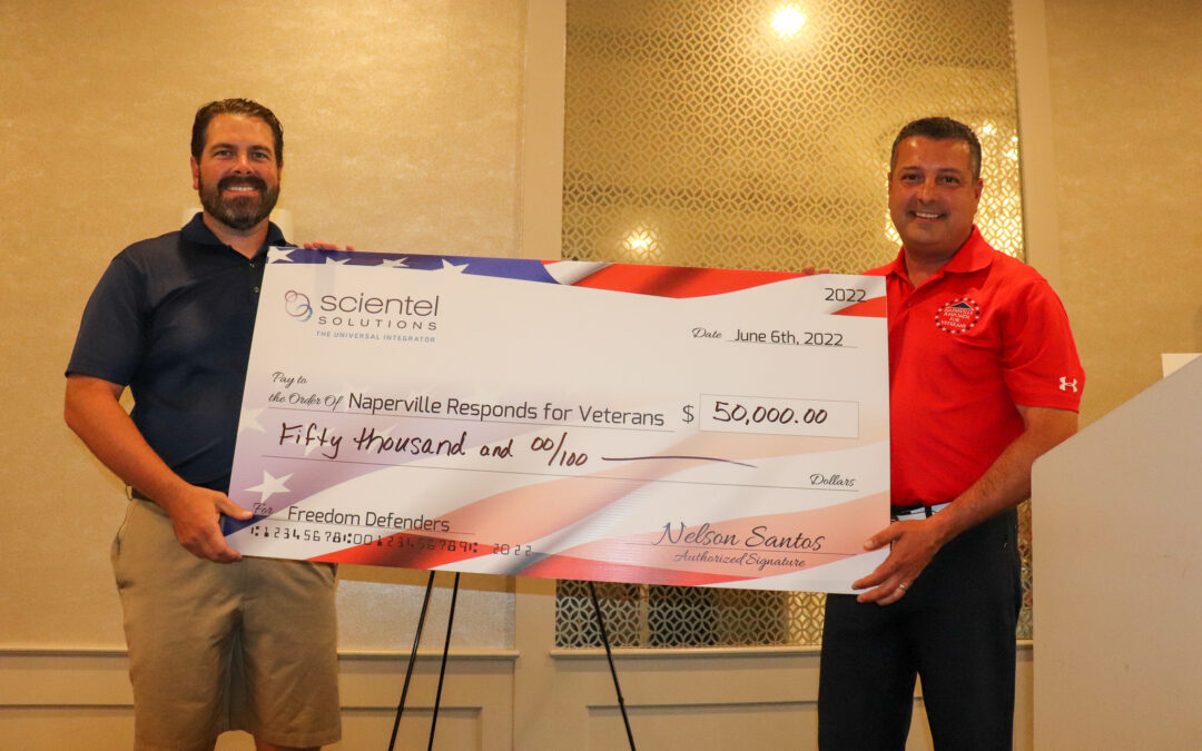 Scientel Solution's CEO handing a check to Naperville Responds for Veterans