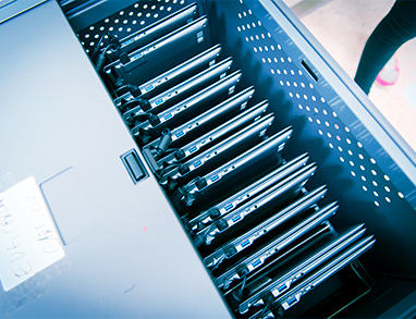 drawer of school laptops plugged in